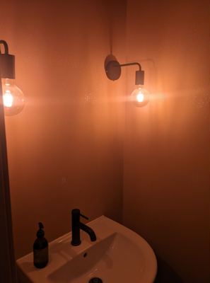 Bathroom sink with wall-mounted lighting fixtures