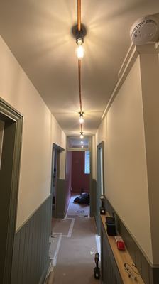 Hallway decorating and pendant lighting installation in progress