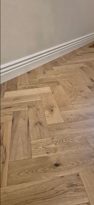 Close-up of oak herringbone parquet flooring installation