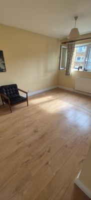 New laminate flooring fitted in a bright empty room