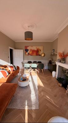 Living and dining room with herringbone flooring and fireplace