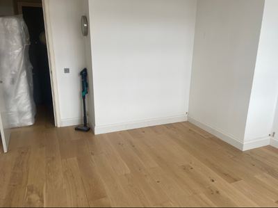 New oak flooring fitted in an empty room