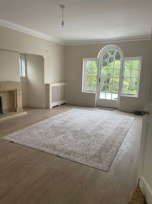 Period living room renovation with arched garden door
